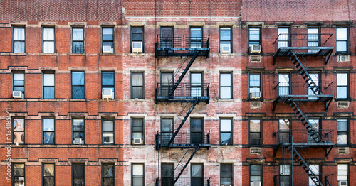 Old brick apartment buildings with windows and fire escapes along Second Avenue in the Upper West Side of Manhattan, New York City NYC