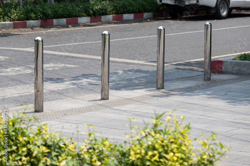 stainless steel bollards at concrete pavement.