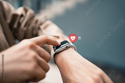 Woman using smart watches with checking pulse via health application. healthcare and people concept.