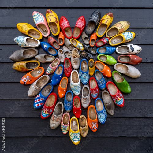 close up view of many colorful traditional clogs hanging on the wall of a house in the Netherlands