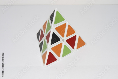 Pyraminx . collection of Rubik's cube puzzles and other puzzles, geometric shapes of pyramids, disassembled Rubik's cube . Pyramid and Rubik's cube 