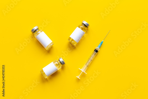 Covid vaccine in bottles with syringe. Top view