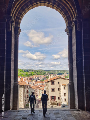 Two pilgrims at the door of the cathedral of Le Puy en Velay, departure of the camino de santiago. 
