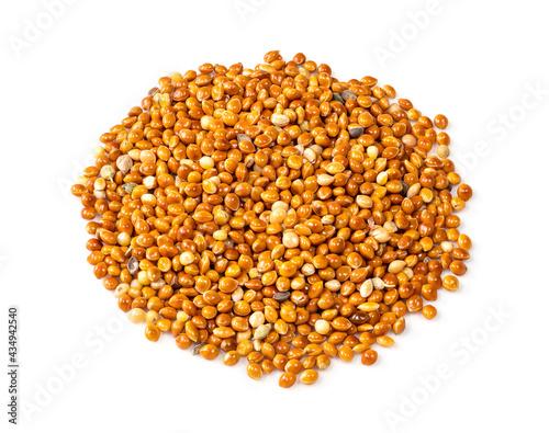 pile of proso millet grains closeup on white