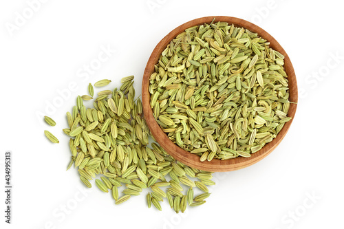 Dried fennel seeds in wooden bowl isolated on white background with clipping path. Top view. Flat lay