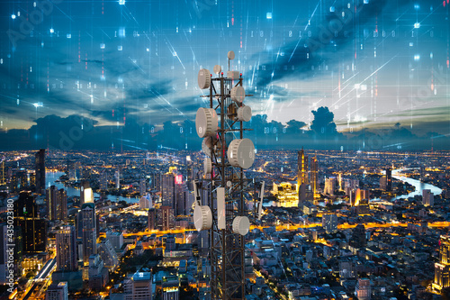 Telecommunication tower with 5G cellular network antenna on night city background, Digital big data concept