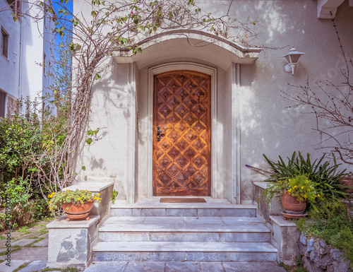 vintage family house front entrance marble steps and decorated wooden door, Athens Greece