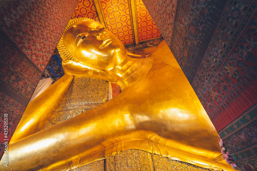 the image of gold reclining Buddha in capital palace wat pho temple bangkok thailand