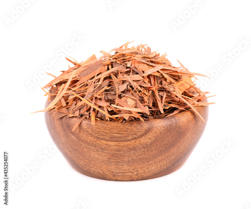 Lapacho herbal tea in wooden bowl, isolated on white background. Natural Taheeboo dry tea. Pau d'arco herb. Tabebuia heptophylla.