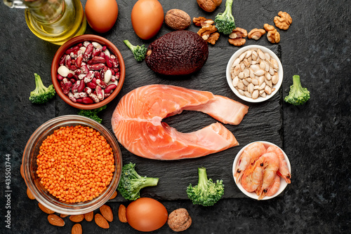 Different foods sources of omega-3 acids on a stone background