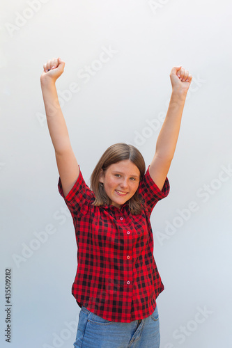 Beautiful caucasian teenager girl very happy and excited doing winner gesture with arms