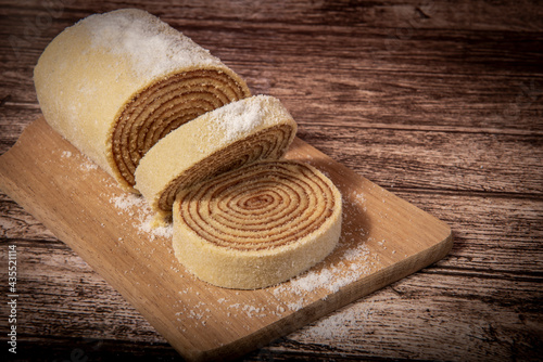 roll cake on wooden board