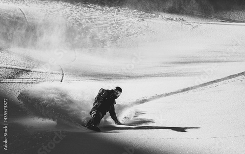 Snowboarder rides on fresh snow