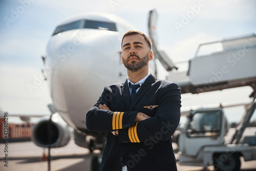 Proud pilot watching straight with a dreamy look