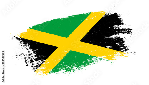 Flag of Jamaica country on brush paint stroke trail view. Elegant texture of national country flag