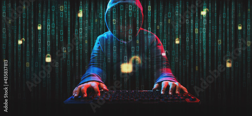 Hacker on screen with binary code.