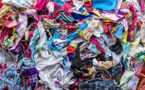 The background of the rag pieces of various colors are stacked together in a scattered mess.