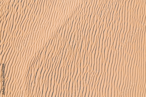 Wind wave vortices in sand background from aerial top view