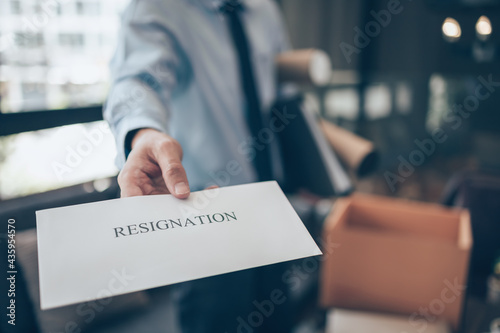 Businessman sending and showing resignation letter to employer boss. Quiting a job, businessman fired or leave a job concpet.