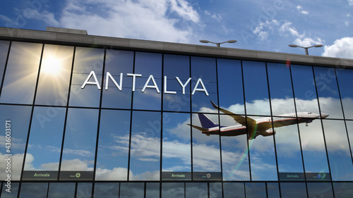 Airplane landing at Antalya Turkey airport mirrored in terminal