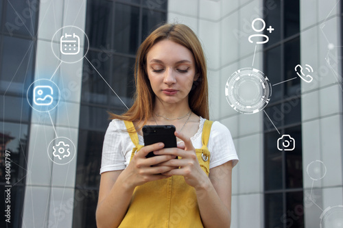 Young girl with a phone in her hands. Modern mobile apps. Teens and social networks.