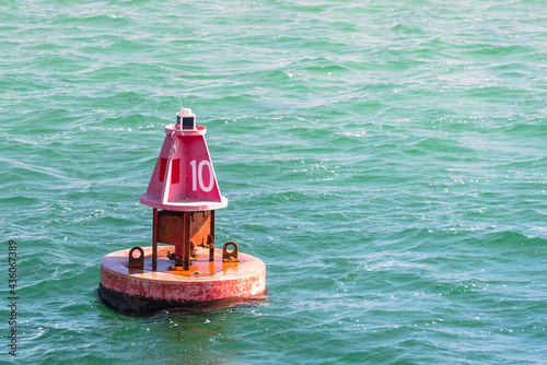 Close up of a red channel marker buoy along a navigable channel to a harbour