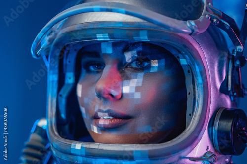 Illuminated studio shot of spacewoman with helmet