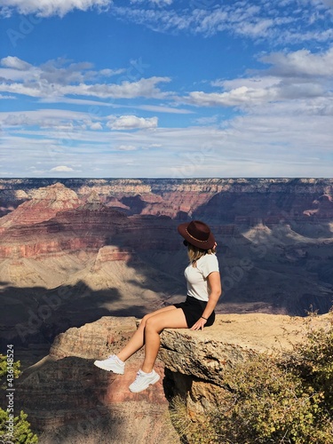 woman sitting on the rock grand canyon romantic landscape, dreaming on the top of the rock woman on the cliff