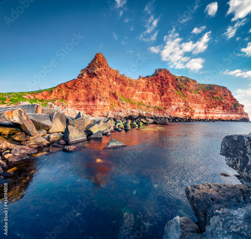 Red cliffs on the coast of Bolata beach. Colorful spring seascape of Black sea. Picturesque outdoor scene of Bulgaria, Europe. Beauty of nature concept background.
