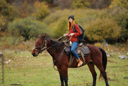 woman hiker travel mountains nature riding horse landscape