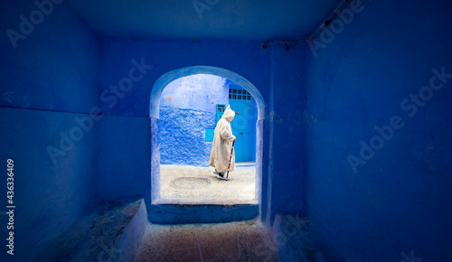 man walking in a street in Chefchaouen, Morocco