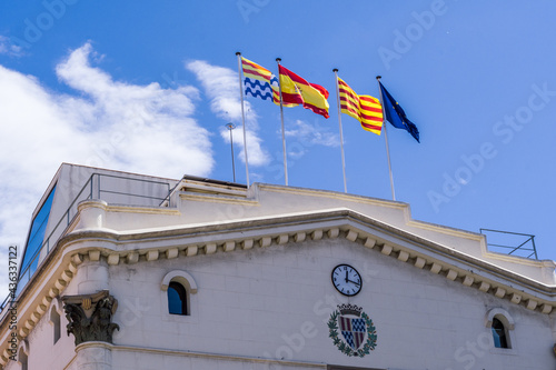 Badalona, Spain - May 13, 2021. Badalona City Council and local, national and European flag waving
