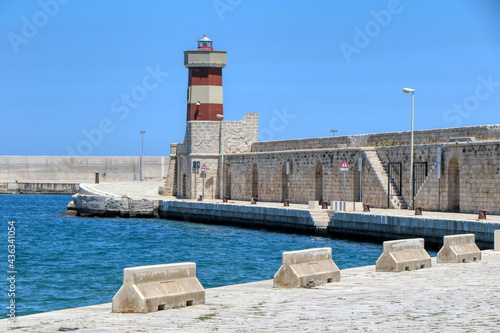 The red lighthouse on the waterfront in the old town of Monopoli, Puglia, Italy.