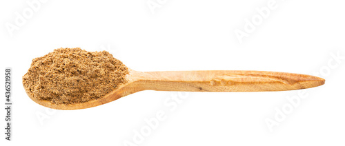 wooden spoon with nutmeg powder isolated on white