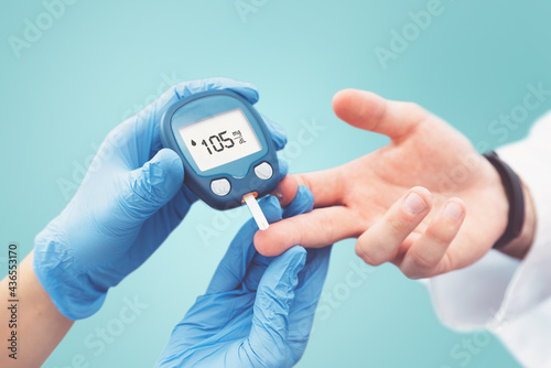 Doctor making blood sugar test. Diabetes treatment