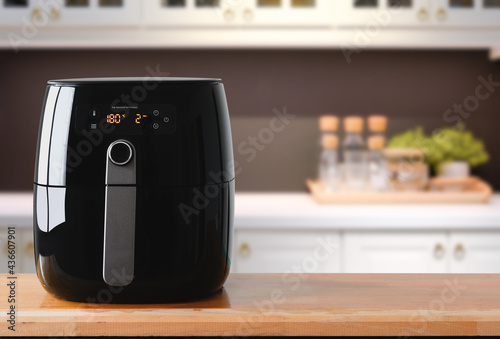 Air fryer machine cooking potato fried in kitchen. Lifestyle of new normal cooking.