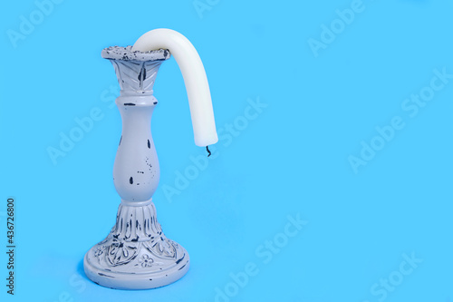 Candle Holder with a Drooping Candle on a Blue Background Concept Impotence Impotence and Old Age in Sex