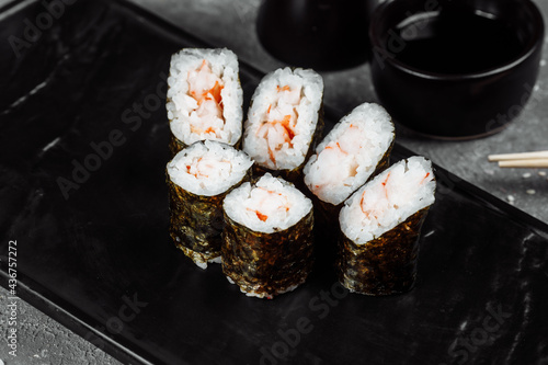 Simple maki with shrimp. Sushi on a gray background