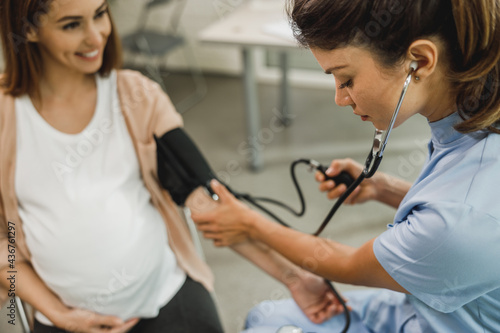 Gynecology Nurse Checking The Blood Pressure Of Pregnant Woman