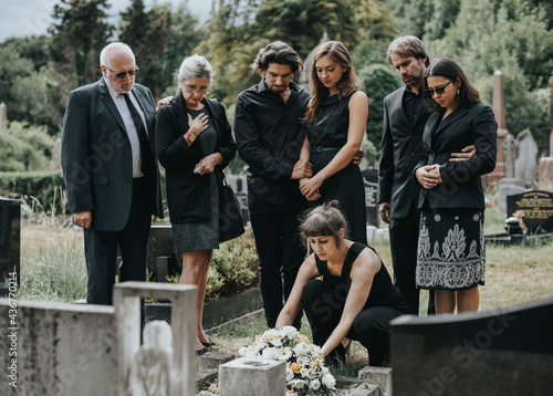 Family laying flowers on the grave