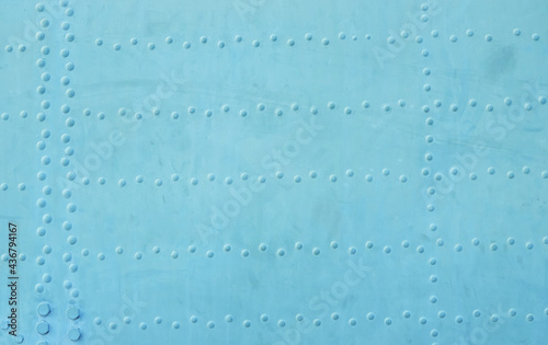 Blue metal texture with rivets. Horizontal format