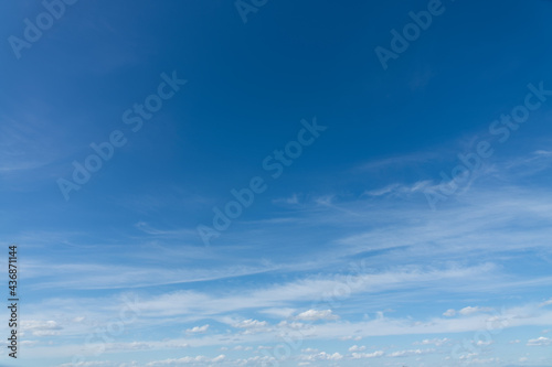 Blue sky with light clouds background, natural sunny day sky replacement