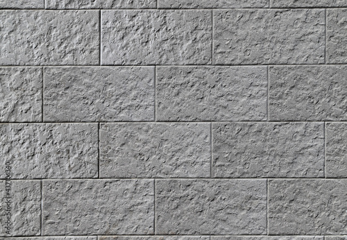 Texture of a decorative stone wall made of gray rectangular blocks