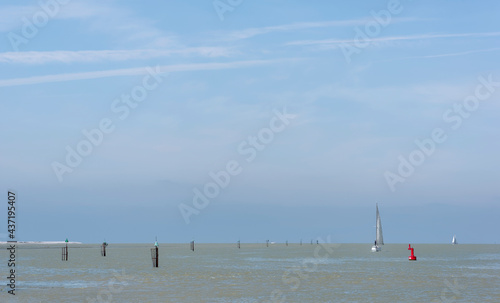 Sailing boat in the chanel of Saint-Valery-sur-Somme village. Bay of the Somme