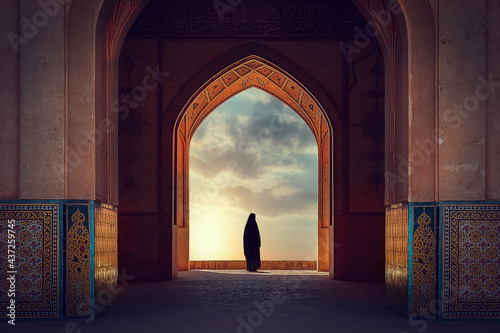 Silhouette of a Persian woman in national dress against the background of traditional Iranian architecture. Sunset. Iran. Kashan.