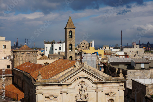 Taranto, Italy - April 7 2015: San Cataldo Cathedral in the foreground, top view. Сityscape, ecology is not very good here. Apulia. Taranto, Italy.