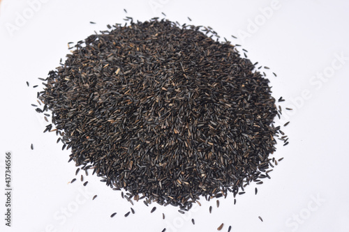 pile of Guizotia abyssinica. Niger seeds on white background