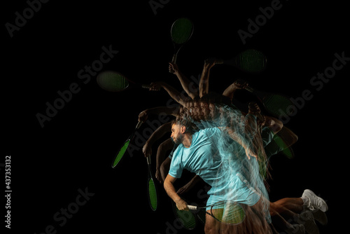 One man, professional tennis player isolated on black background in mixed neon light. Stroboscope