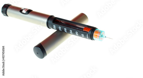 Insulin pen injector. Insulin pen fill with needle on white background. Diabetes Day.