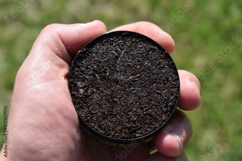 Can of Chewing Tobacco Held in a Hand